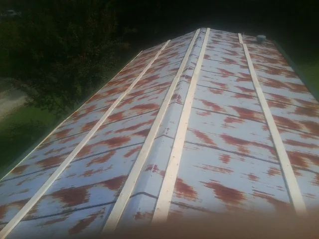 Rusted metal roof panels with new wood purlins before replacement — Storm Damage Roof Repair in Russellton by Roofing Brothers