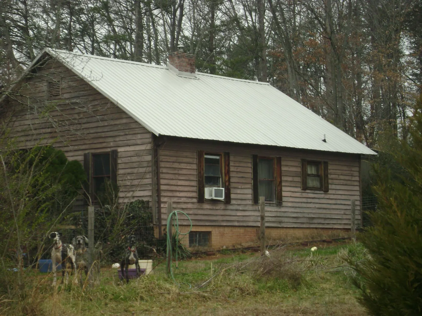 White metal roof on an old wood sided farmhouse, from a Metal Roof Installation job in Russellton